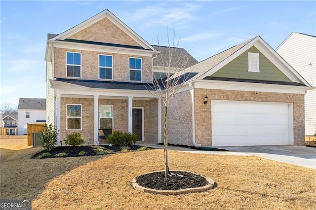 traditional home with concrete driveway, brick siding, an attached garage, and covered porch