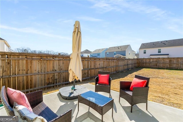 view of patio / terrace with a fenced backyard and a residential view