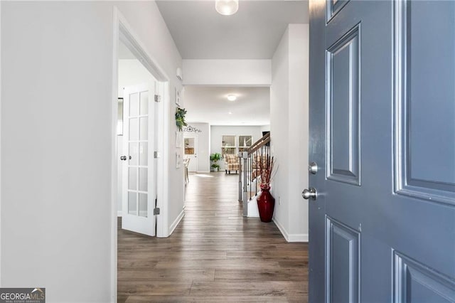 foyer entrance featuring stairway, dark wood finished floors, and baseboards