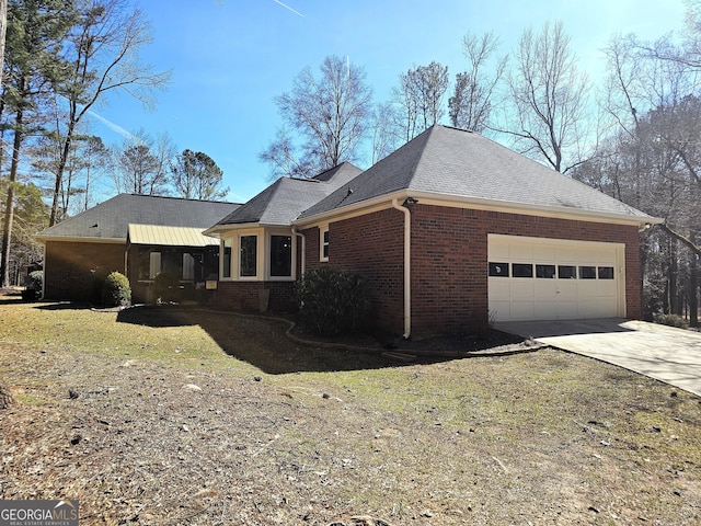 view of property exterior with a garage, concrete driveway, brick siding, and roof with shingles