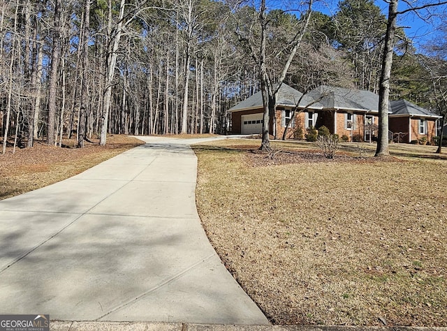 view of front of house with a garage, driveway, and a front lawn