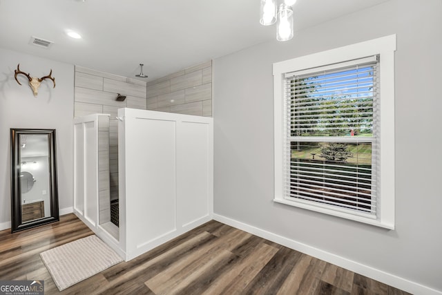 interior space featuring visible vents, baseboards, and wood finished floors