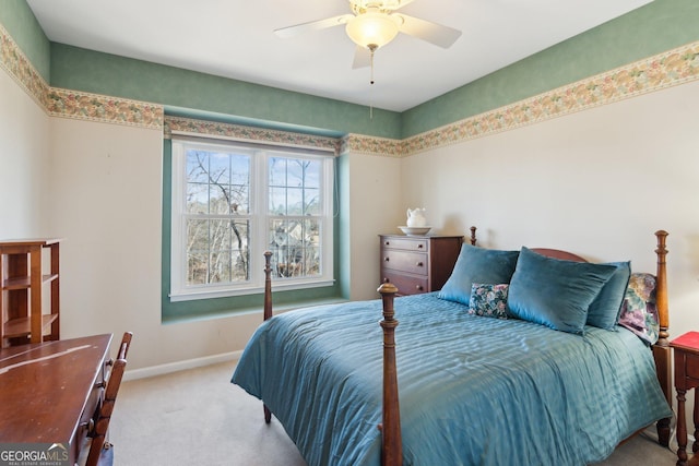 carpeted bedroom with ceiling fan and baseboards