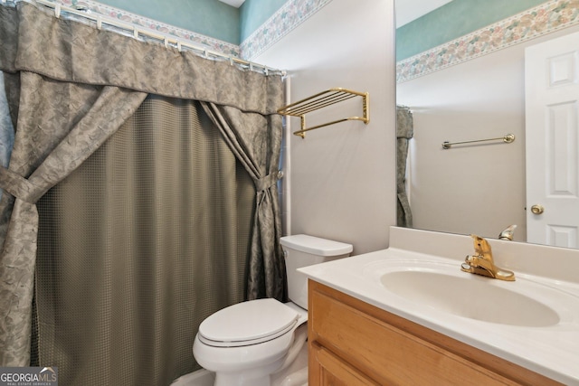 bathroom featuring vanity, toilet, and a shower with curtain