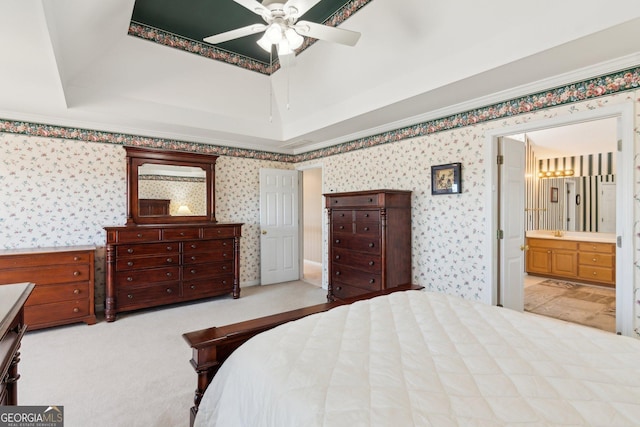 bedroom featuring carpet floors, wallpapered walls, and a tray ceiling