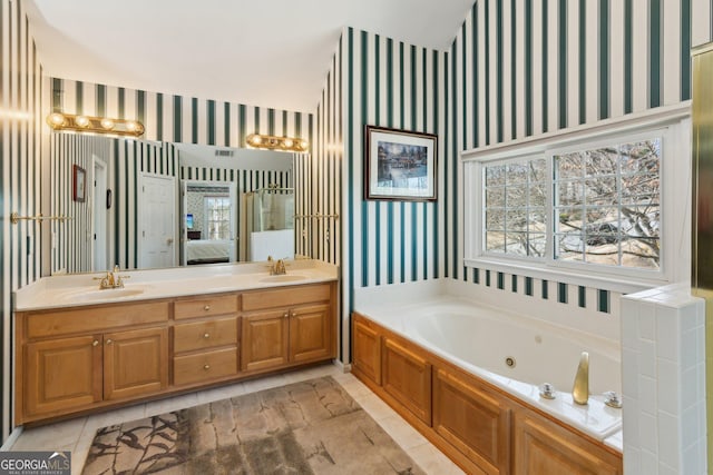 full bath with connected bathroom, a sink, a whirlpool tub, double vanity, and wallpapered walls