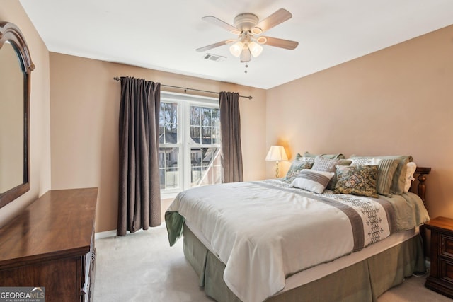 bedroom featuring light carpet, ceiling fan, visible vents, and baseboards