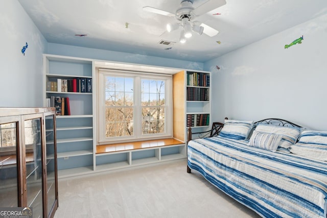 carpeted bedroom featuring visible vents