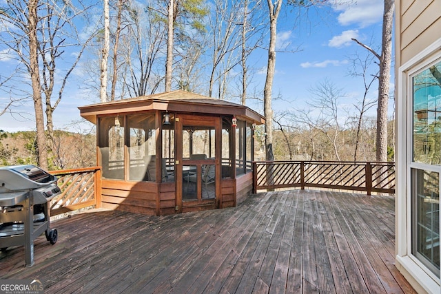 wooden terrace featuring a sunroom and grilling area