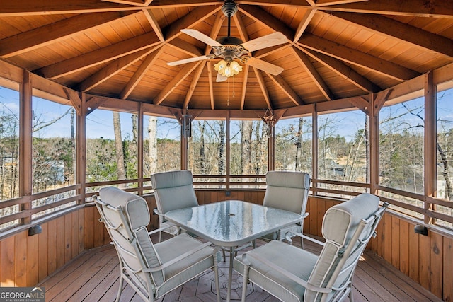 unfurnished sunroom featuring wood ceiling, ceiling fan, and lofted ceiling with beams