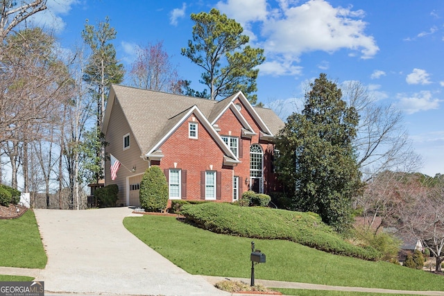 view of front of home featuring an attached garage, a front lawn, concrete driveway, and brick siding