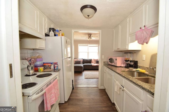 kitchen with a textured ceiling, under cabinet range hood, white appliances, a sink, and white cabinets