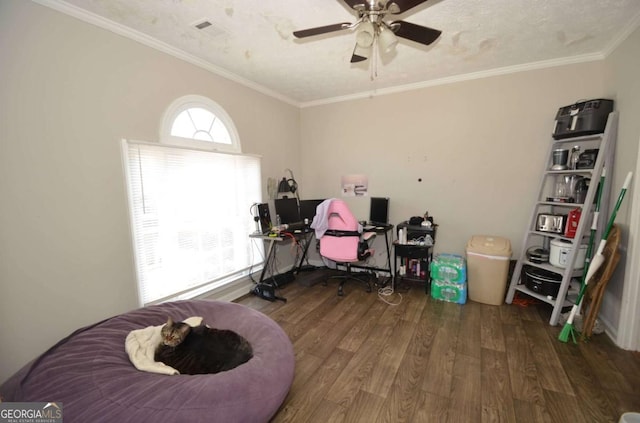 interior space with crown molding, visible vents, ceiling fan, and wood finished floors