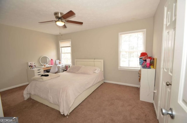 bedroom with ceiling fan, carpet, and baseboards