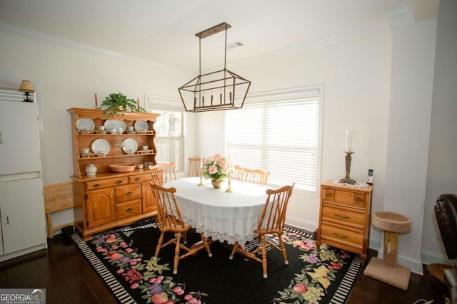 dining area featuring baseboards, visible vents, dark wood-style flooring, and ornamental molding