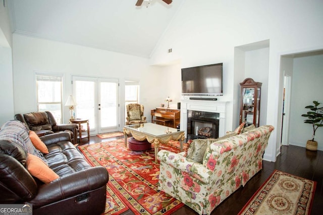 living area featuring a ceiling fan, dark wood-style flooring, french doors, a fireplace, and high vaulted ceiling