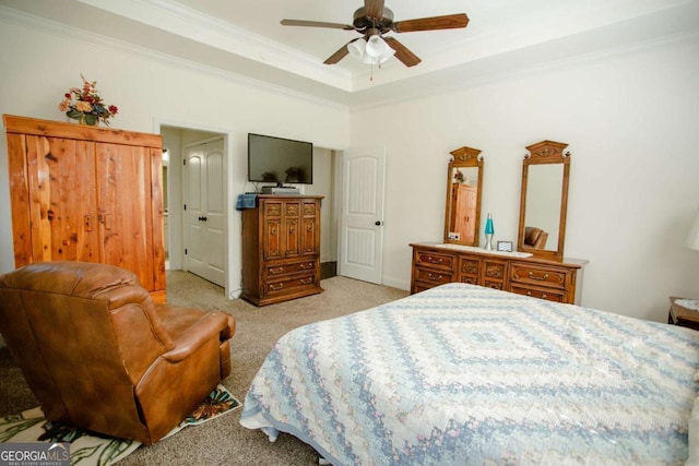 bedroom with ornamental molding, a raised ceiling, light carpet, and ceiling fan