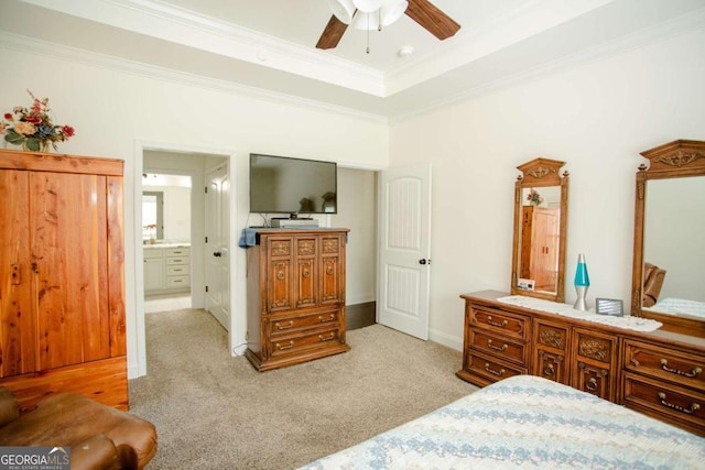 bedroom featuring a raised ceiling, light carpet, and crown molding