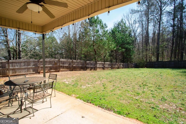 view of yard featuring outdoor dining area, a fenced backyard, ceiling fan, and a patio