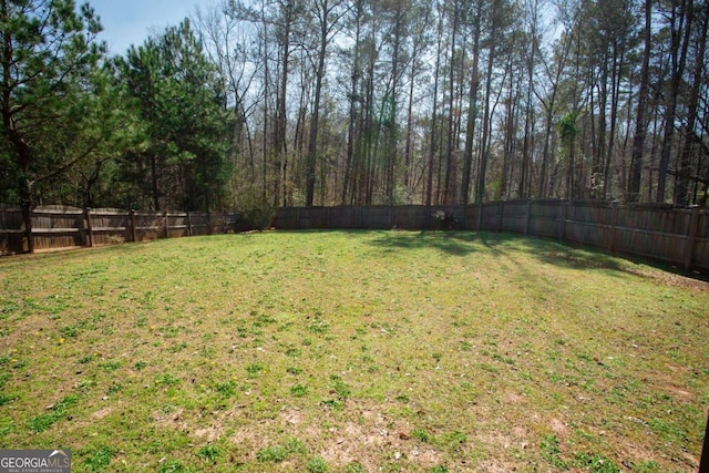 view of yard with a fenced backyard