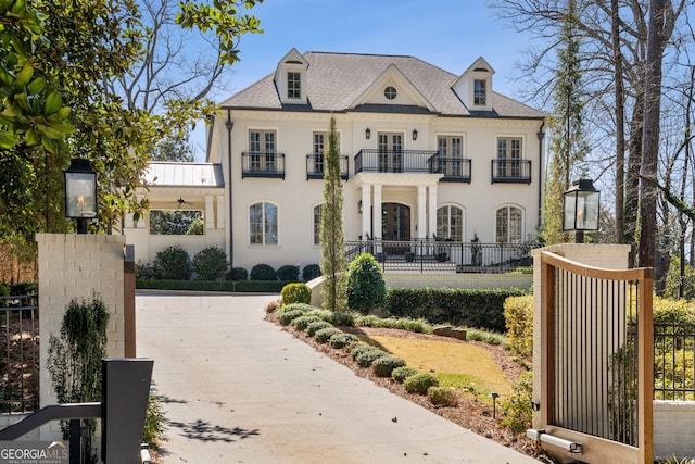 french country inspired facade featuring fence and a balcony