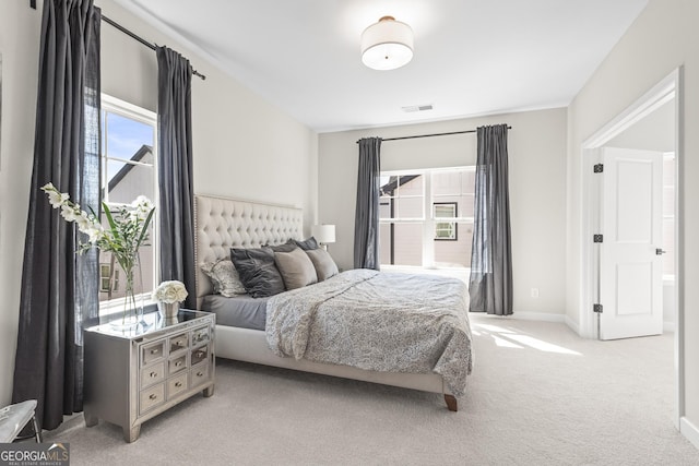 bedroom featuring light carpet, baseboards, and visible vents