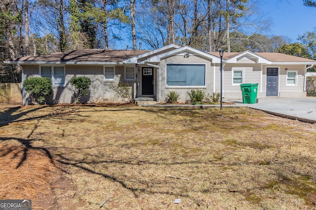 single story home featuring brick siding, crawl space, and a front yard