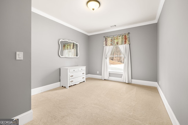 empty room featuring light carpet, visible vents, baseboards, and crown molding