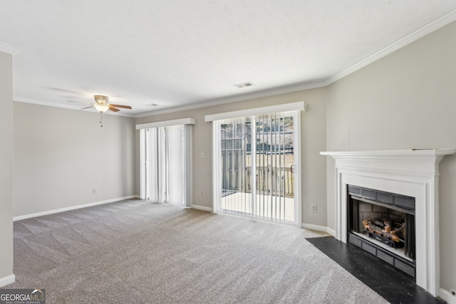 unfurnished living room with carpet floors, visible vents, crown molding, and a fireplace with flush hearth