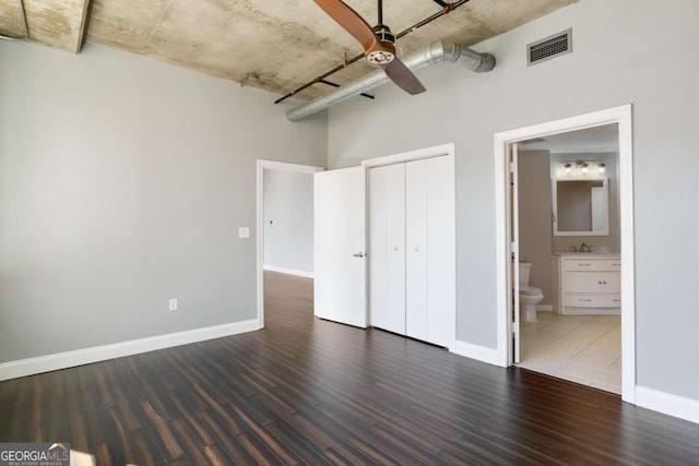 unfurnished bedroom with wood finished floors, visible vents, and baseboards