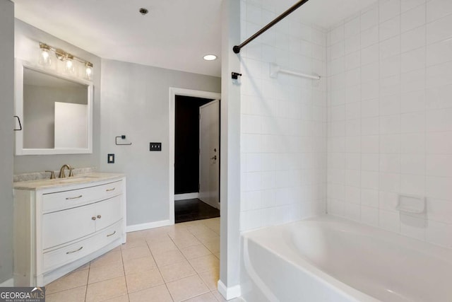 full bath with baseboards, vanity, and tile patterned floors