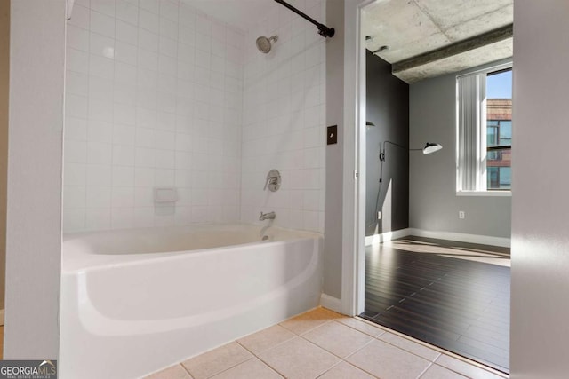 full bathroom with  shower combination, tile patterned flooring, and baseboards