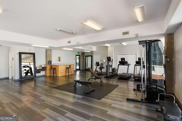 exercise room with visible vents and wood finished floors