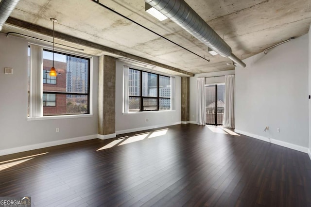 empty room with dark wood-type flooring and baseboards