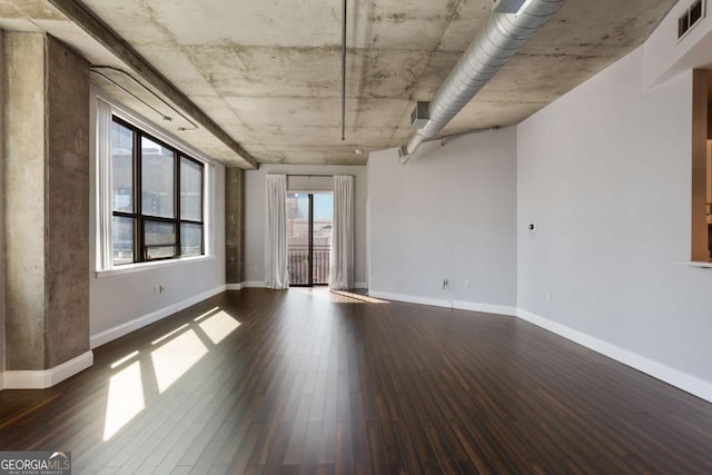 unfurnished room with visible vents, baseboards, and wood finished floors