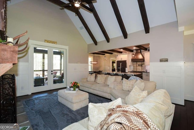 living room with high vaulted ceiling, french doors, wainscoting, and beam ceiling