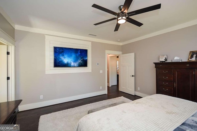 bedroom featuring ceiling fan, dark wood-type flooring, visible vents, baseboards, and ornamental molding