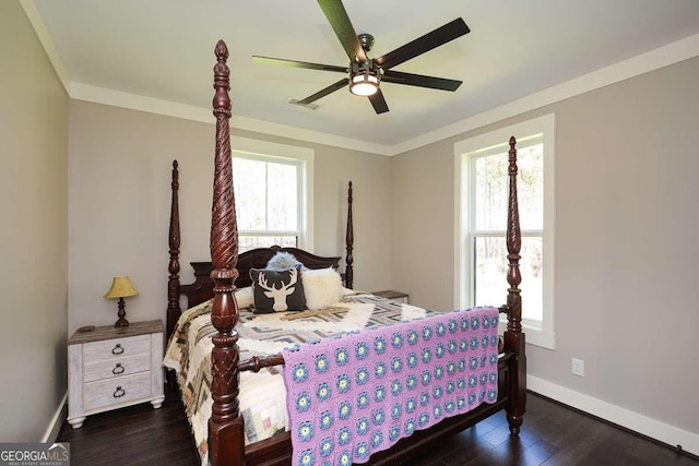 bedroom featuring ornamental molding, wood finished floors, visible vents, and baseboards