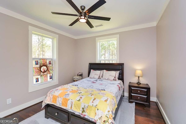 bedroom featuring visible vents, ceiling fan, baseboards, and wood finished floors