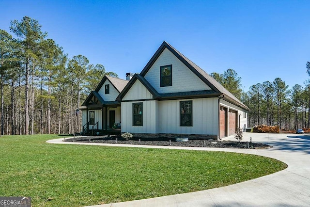 modern farmhouse with driveway, a garage, a chimney, board and batten siding, and a front yard