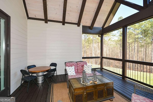 sunroom featuring vaulted ceiling with beams and wooden ceiling