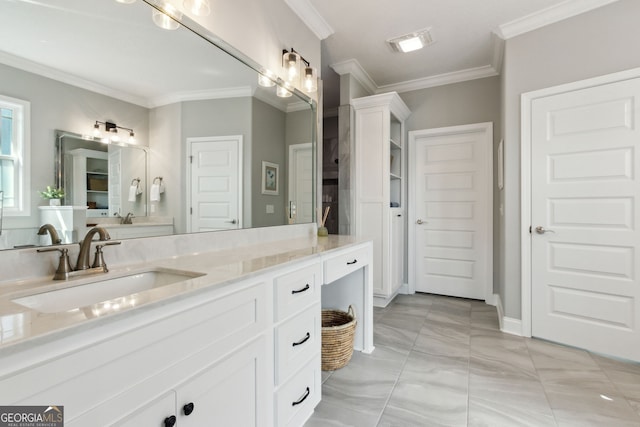 bathroom with baseboards, visible vents, crown molding, and vanity