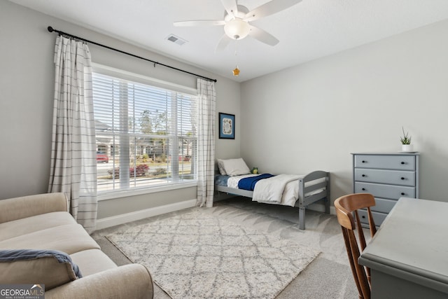 carpeted bedroom with visible vents, ceiling fan, and baseboards