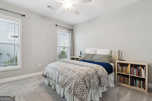 bedroom with baseboards, visible vents, ceiling fan, and carpet flooring