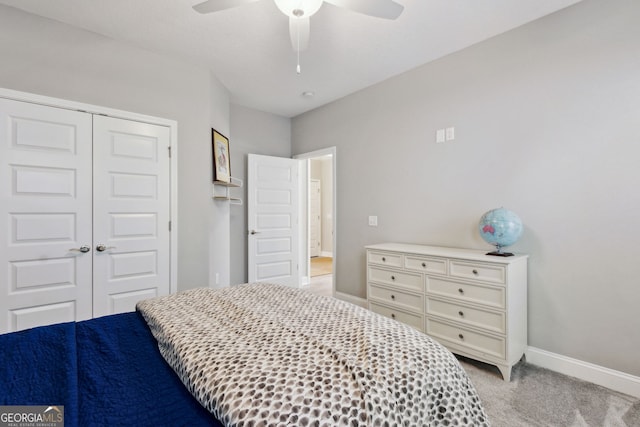 bedroom with baseboards, ceiling fan, a closet, and light colored carpet