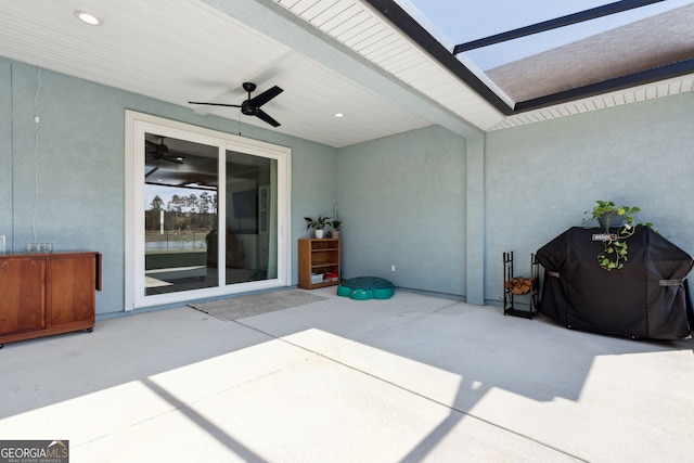 view of patio / terrace with glass enclosure and a ceiling fan