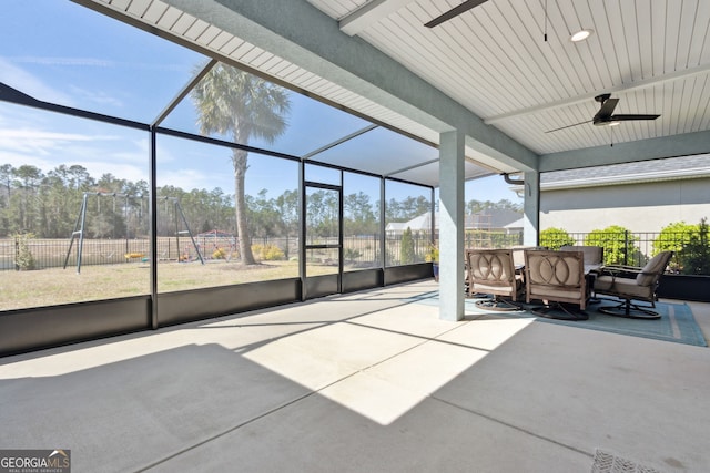 unfurnished sunroom with a ceiling fan