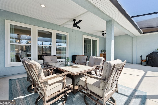 view of patio / terrace with a grill, a ceiling fan, and outdoor dining space