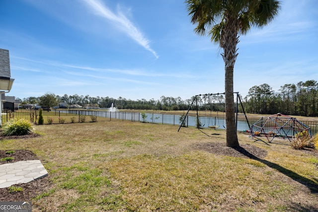 view of yard featuring a water view and fence