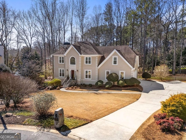 view of front of home featuring a front lawn, a chimney, and fence